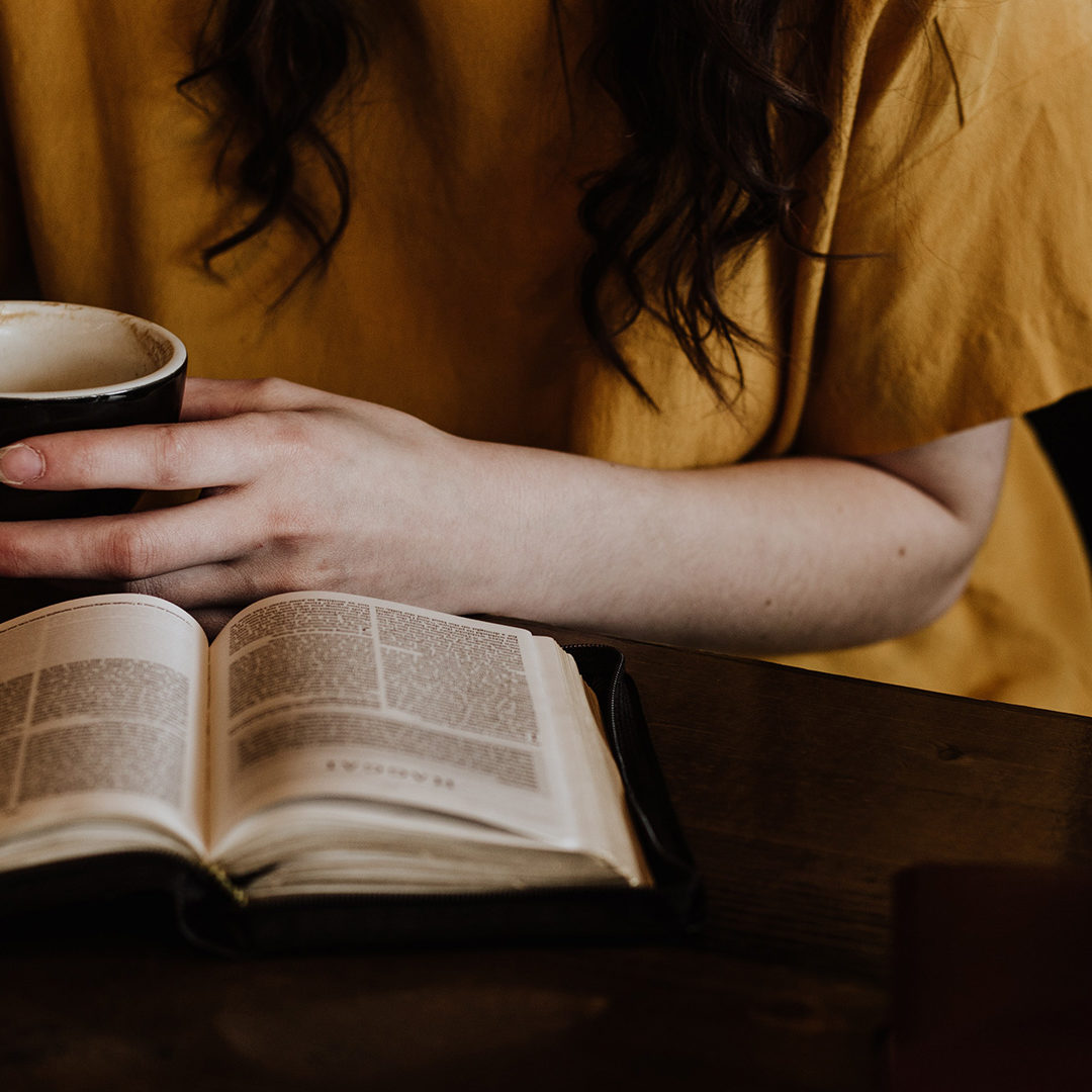 woman-holding-mug-in front-of-Bible